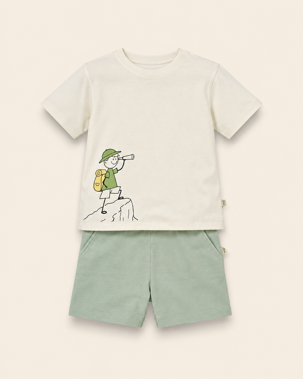 Cream Little Explorer kids coord set with sage green shorts, laid flat front view