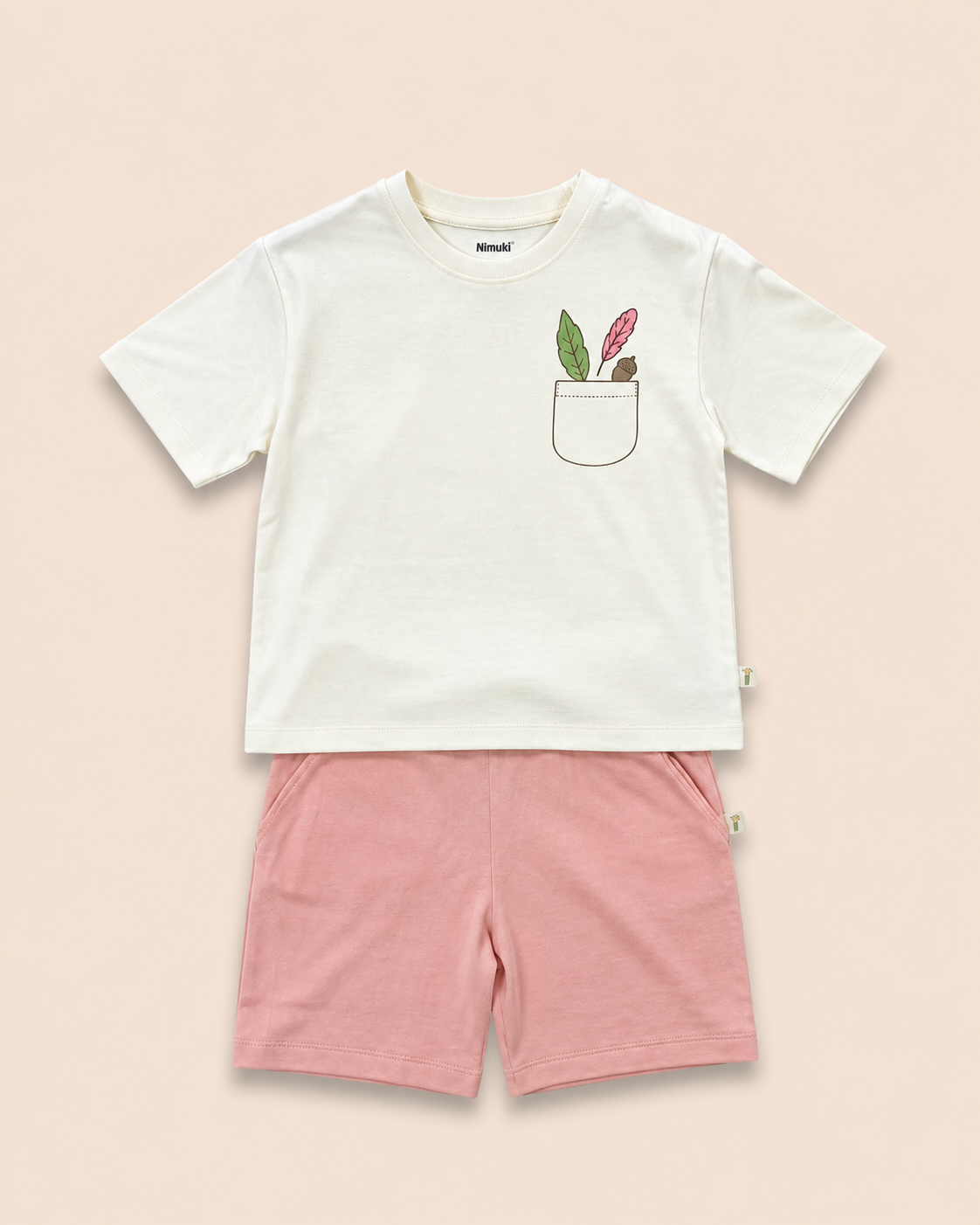 Cream Pocket Discovery kids coord set with peach shorts, laid flat front view
