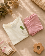 Cream Pocket Discovery kids coord set with peach shorts, folded flat lay showing fabric detail
