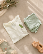 Cream Pocket Discovery kids coord set with sage green shorts, folded flat lay showing fabric detail