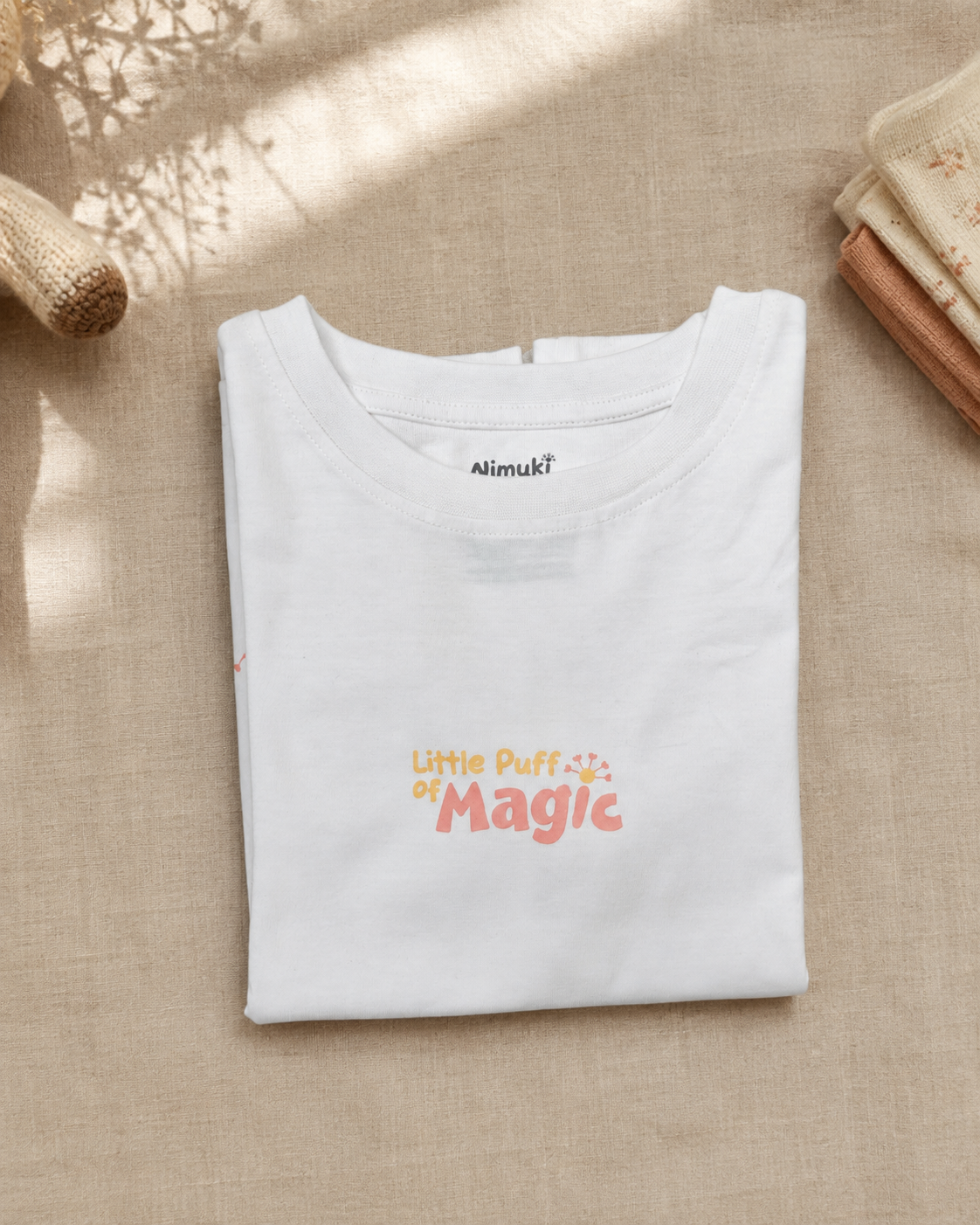 Little Puff of Magic white kids graphic t-shirt, folded flat lay showing fabric detail