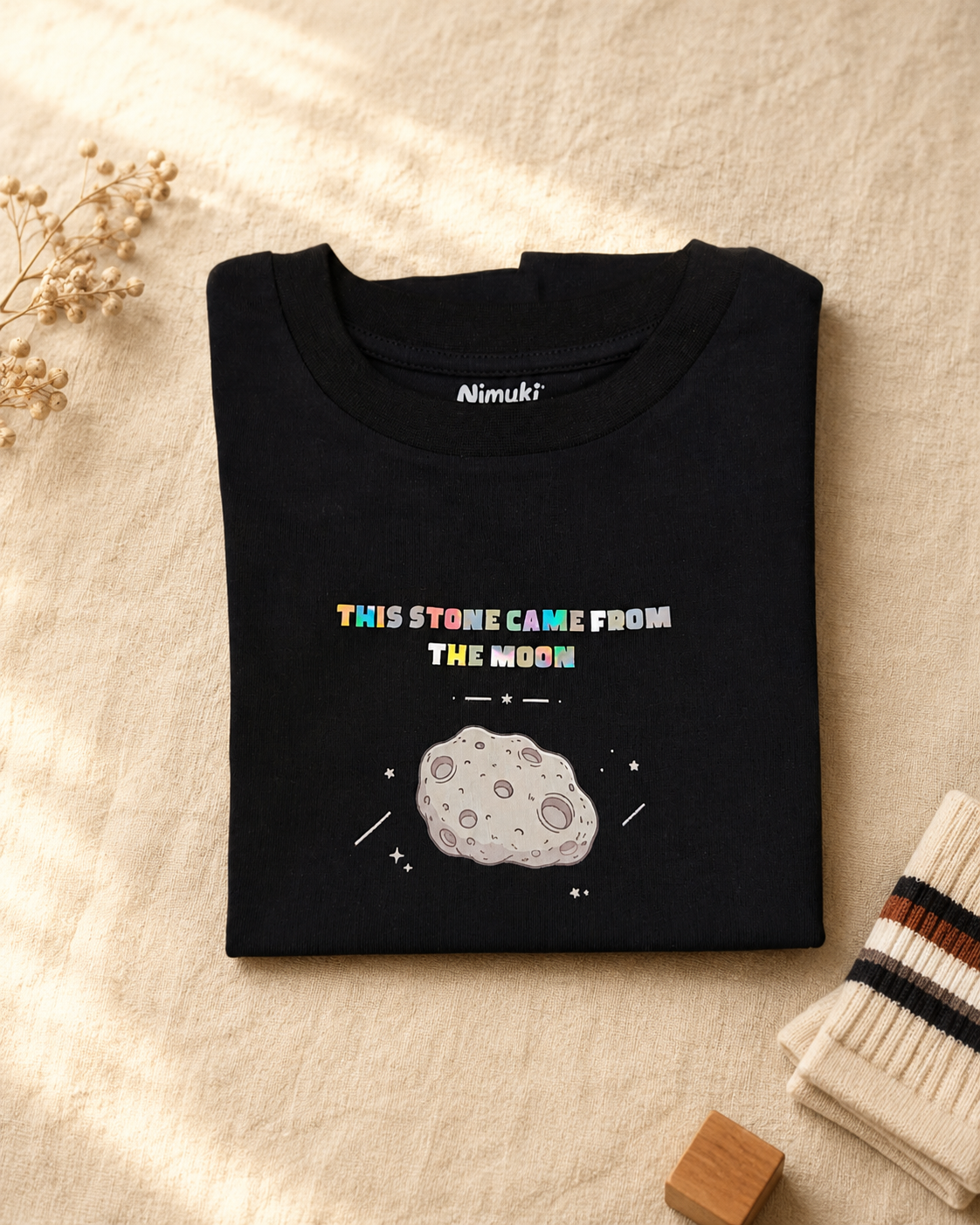 Moon Rock black kids graphic t-shirt, folded flat lay showing fabric detail
