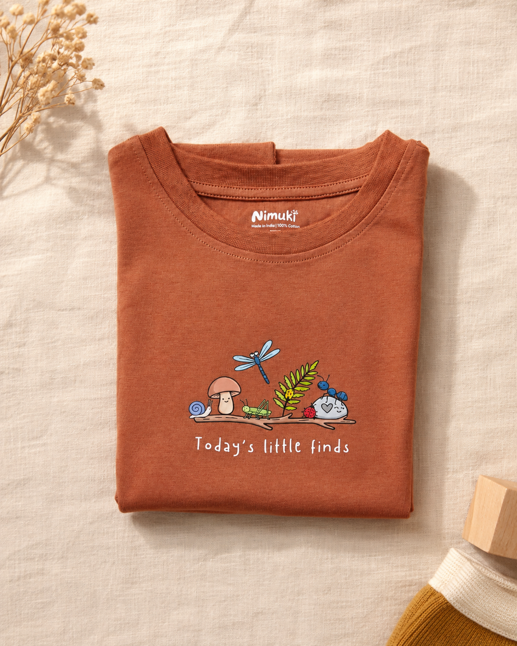 Today's Little Finds teracotta kids graphic t-shirt, folded flat lay showing fabric detail