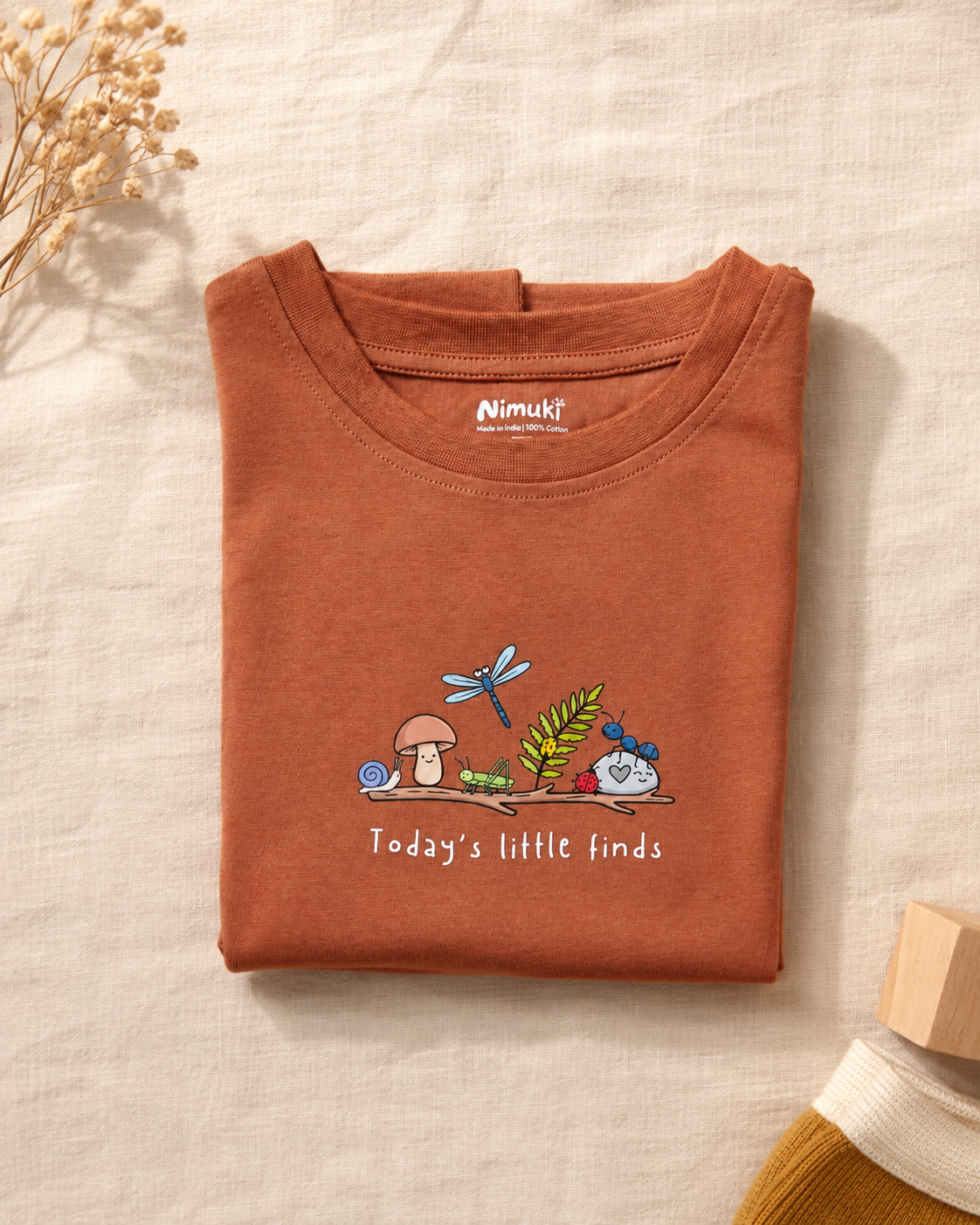 Today's Little Finds teracotta kids graphic t-shirt, folded flat lay showing fabric detail